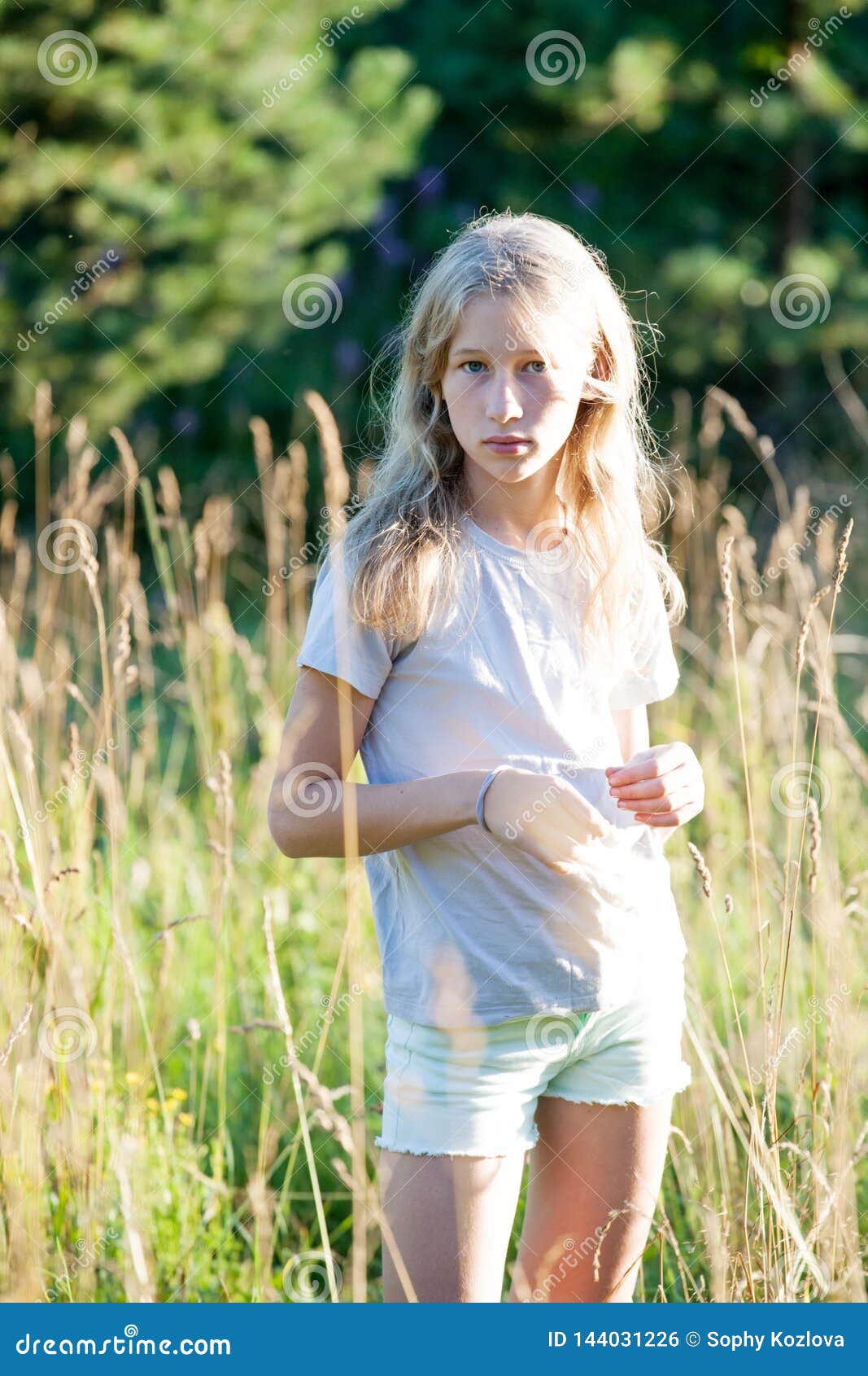 Teen Blonde White Girl Standing On Green Summe