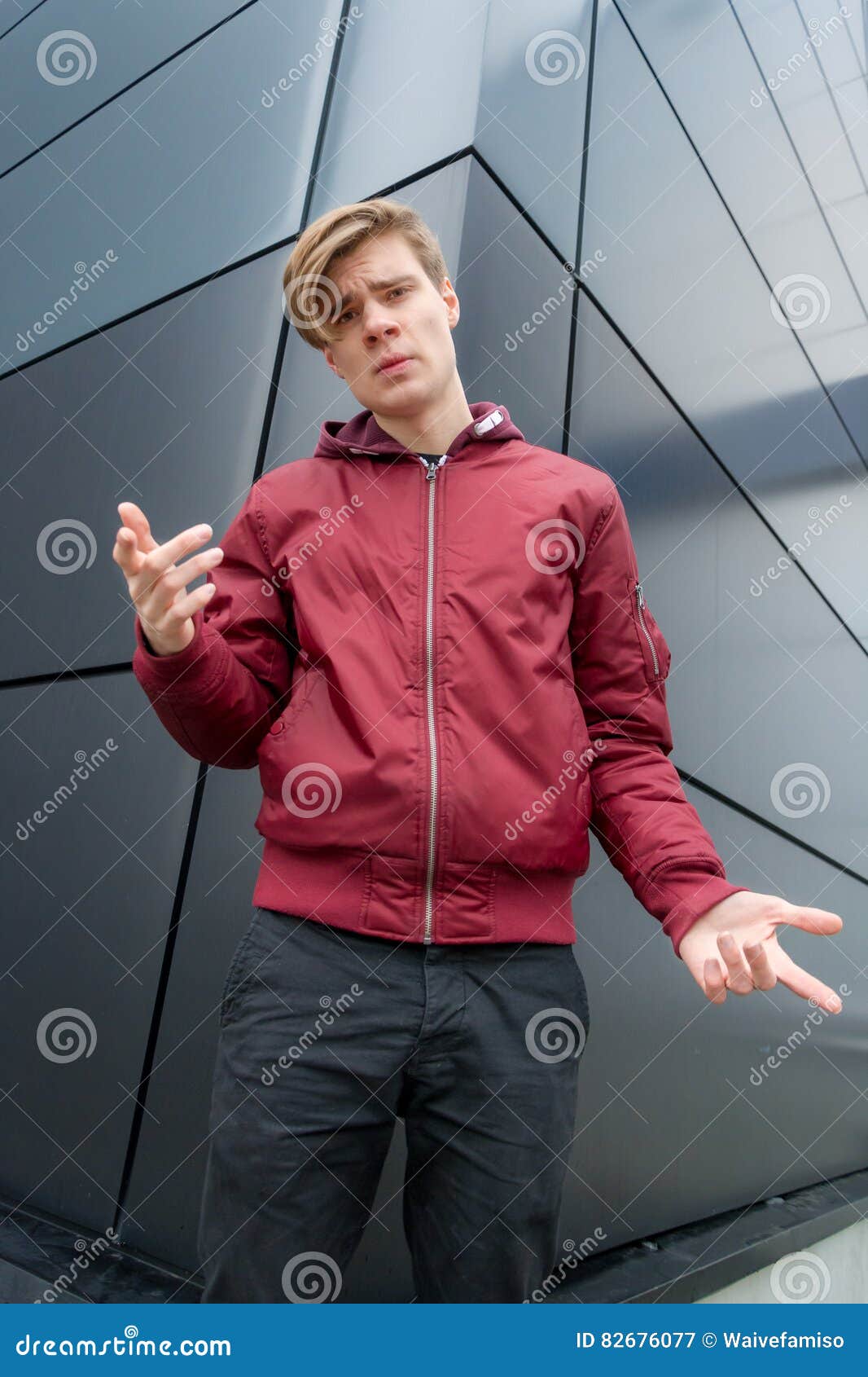 teen boy gesticulating to express doubt about decision