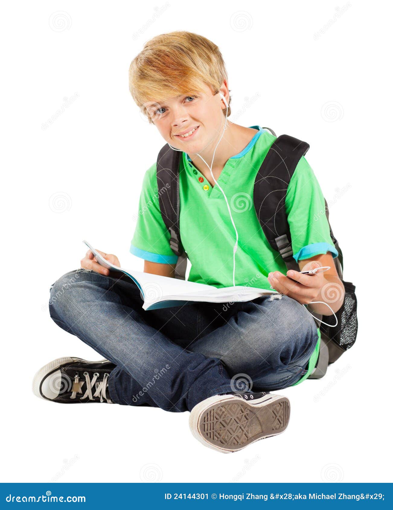 Teen boy reading. Teen boy sitting on floor reading book isolated on white