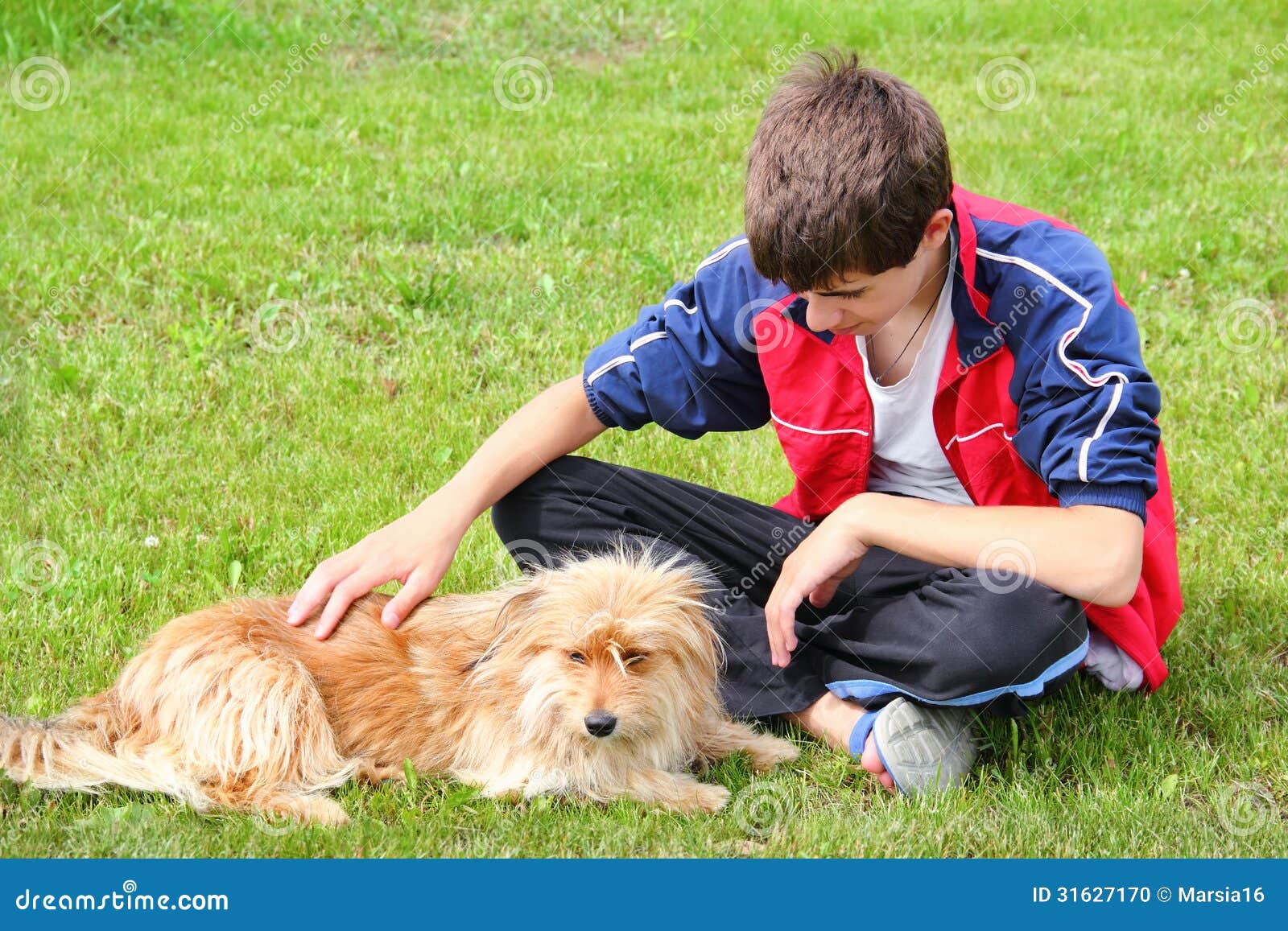 teen boy stroking his dog