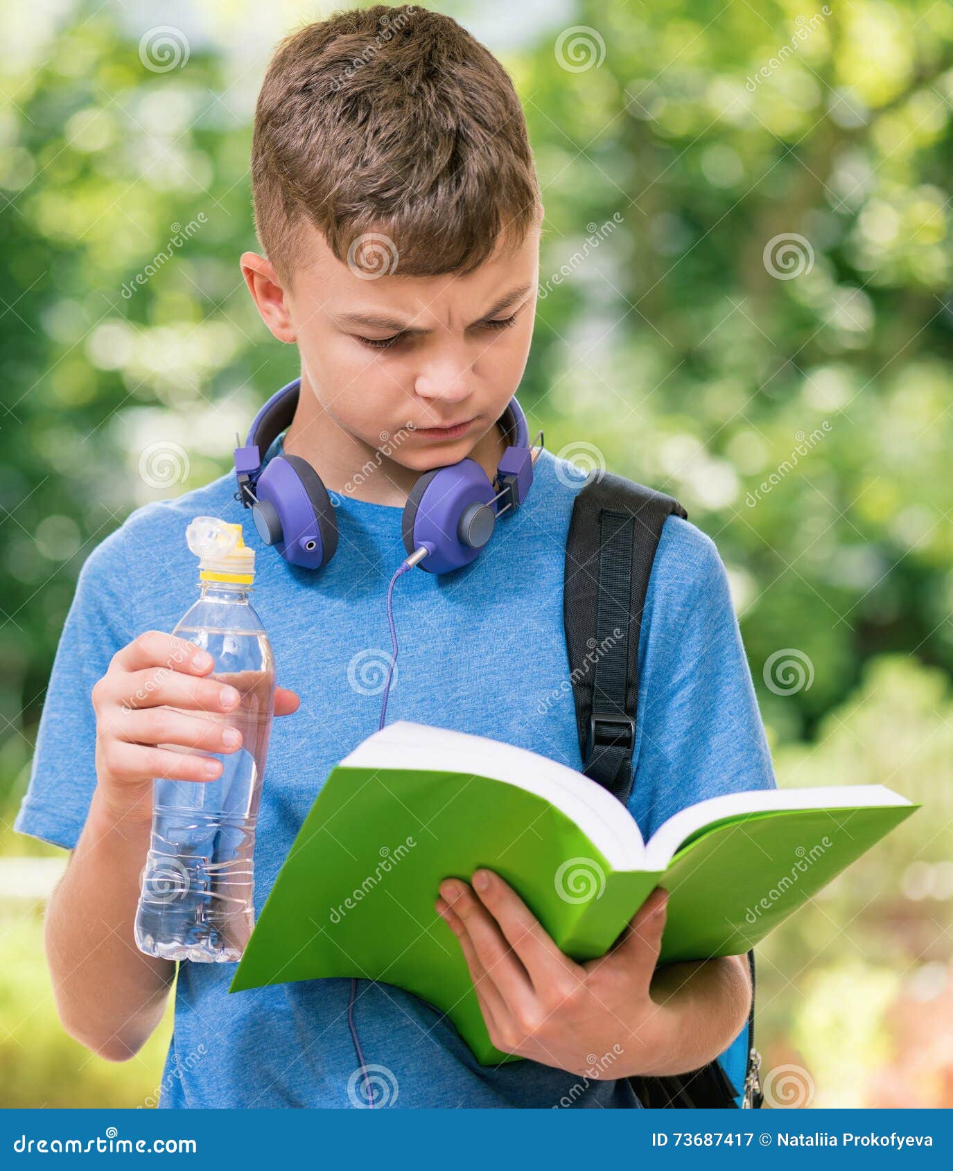 Teen boy with water stock image. Image of book, person - 73687417