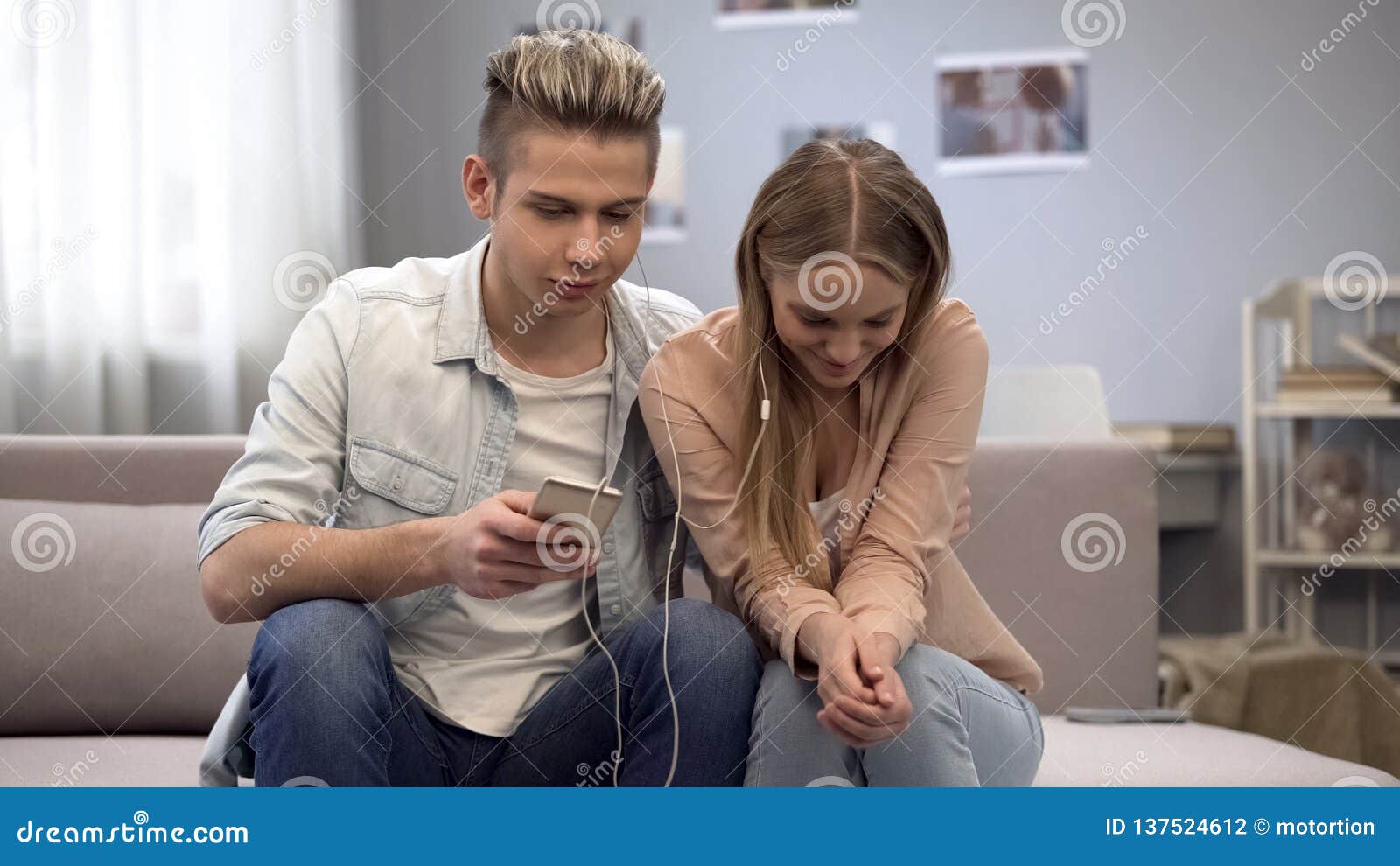 Teen Couple Listening To Music Together Shy To Communicate On First