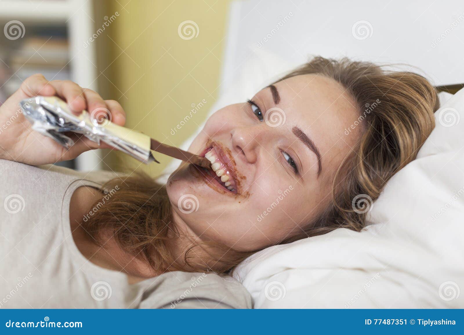 Teen Girl In Bed Eating Chocolate Stock Image Im