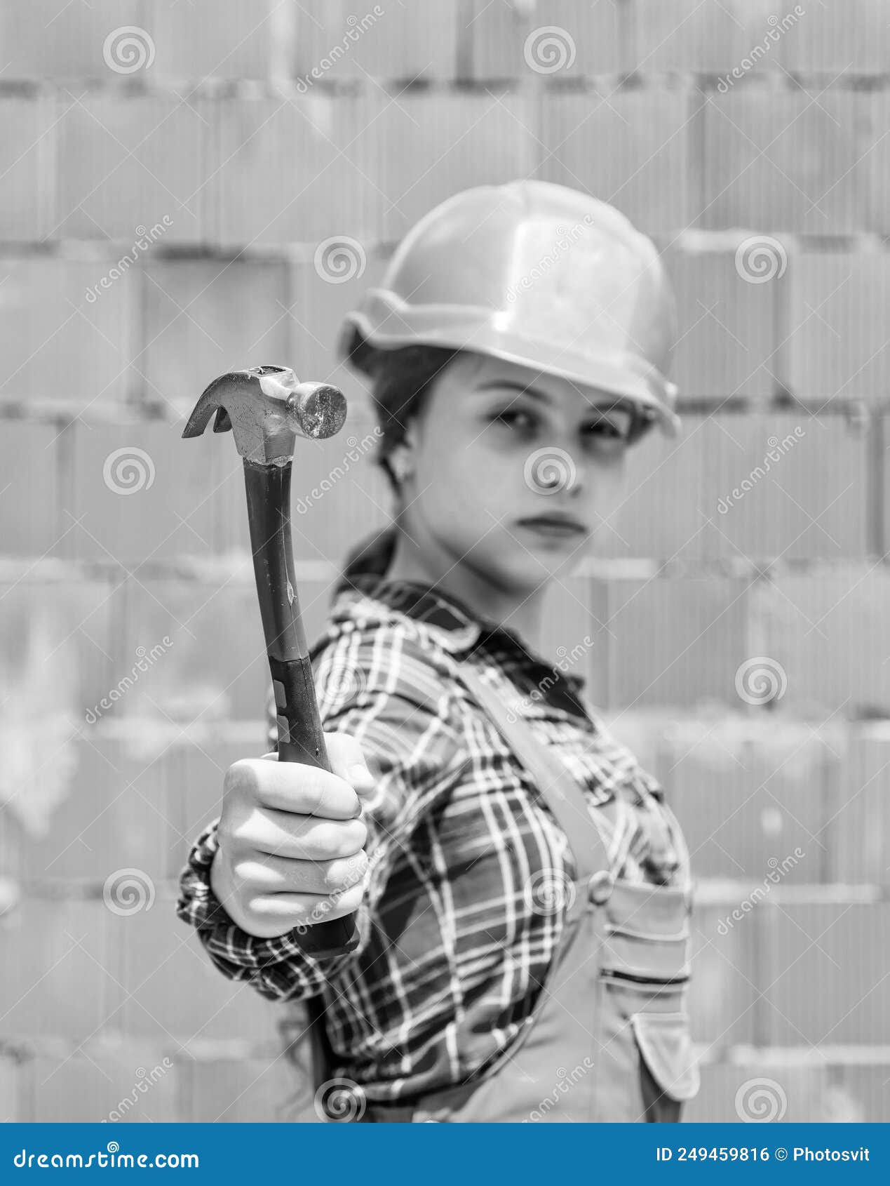 Teen Girl Builder In Protective Helmet Use Hammer Building Tool Stock