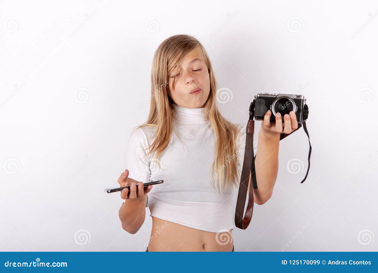 teen girl cant choose between smartphone and compact camera