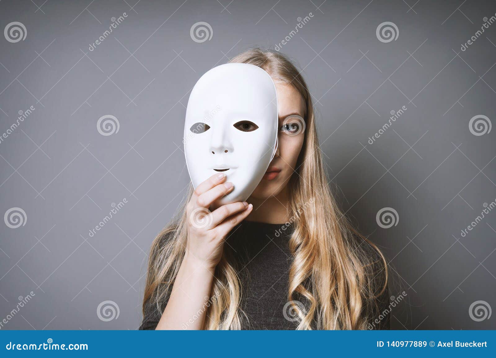 teen girl hiding face behind mask