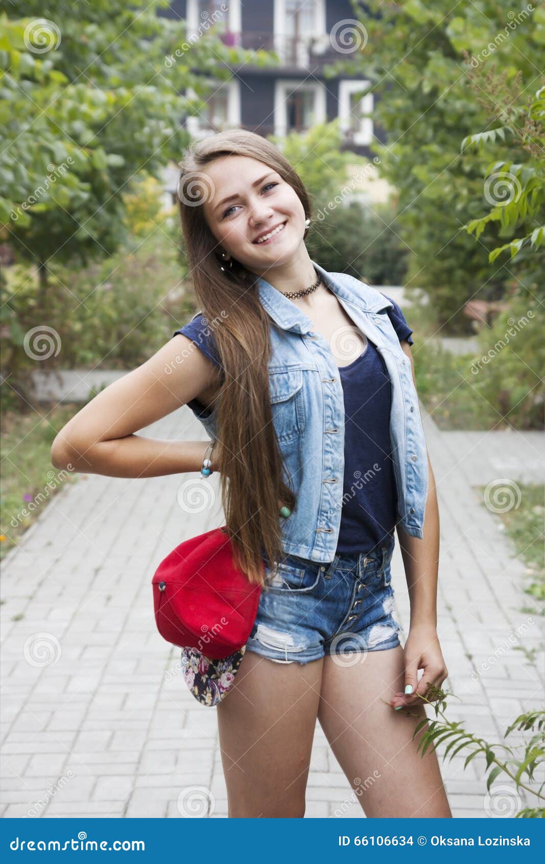 Tween Girl With Trendy Pink Hair, Wearing Jeans, Smiles Slightly While ...