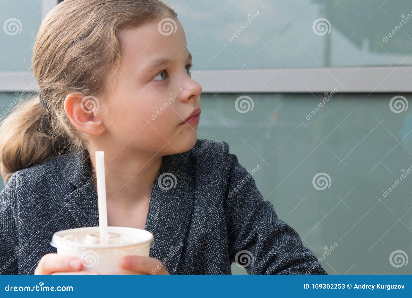 teen girl, looking at the interlocutor, portrait, holding a drink with a straw