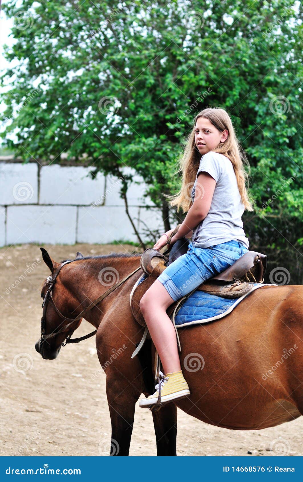 Teen girl riding horse stock photo