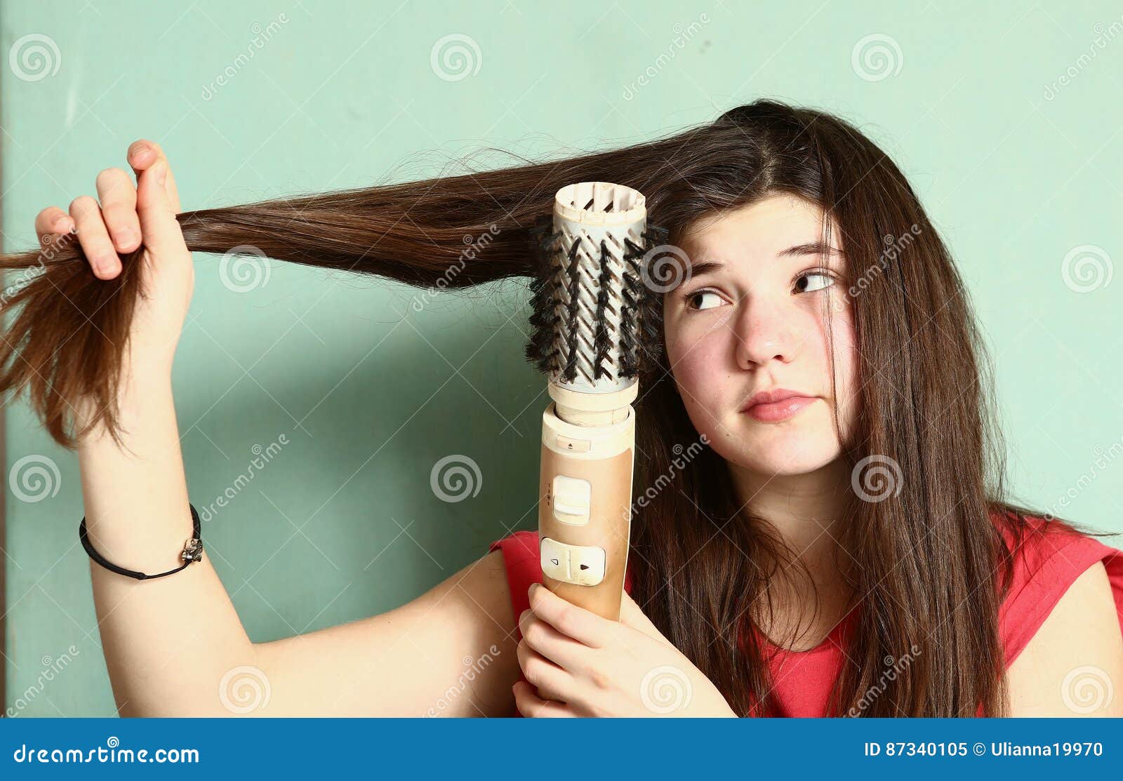 teen girl straighten her long brown hair