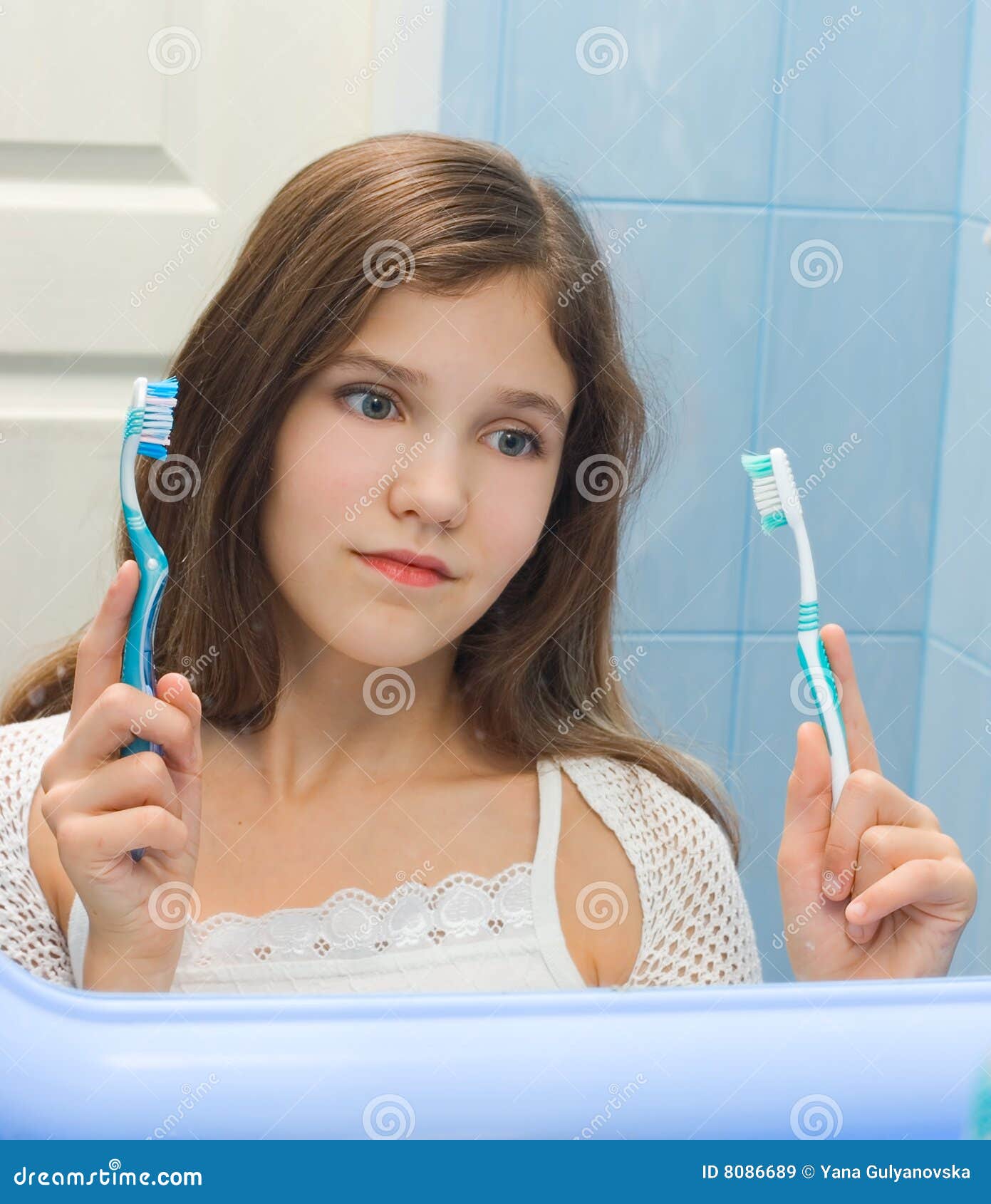 teen girl to decide between the two toothbrushes