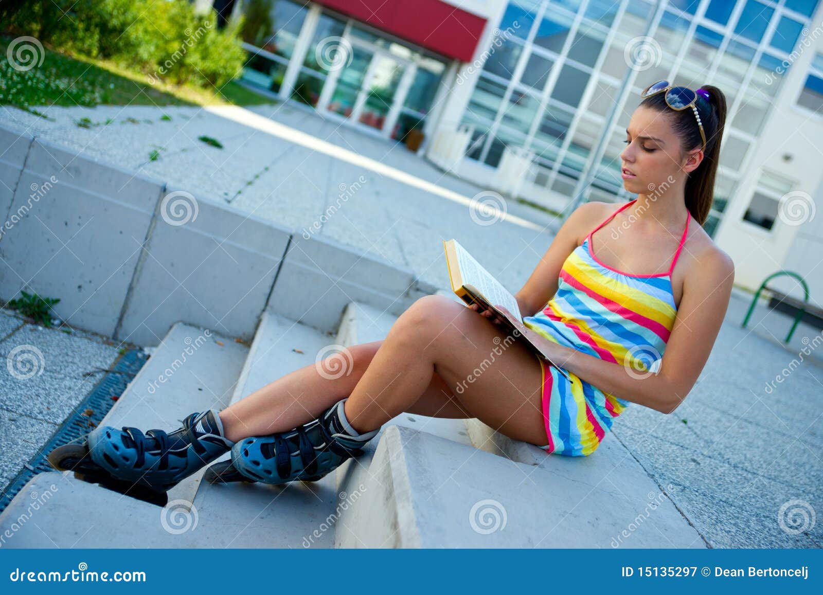 Teen Girl Wearing Roller Skates With Book Royalty Free Stock