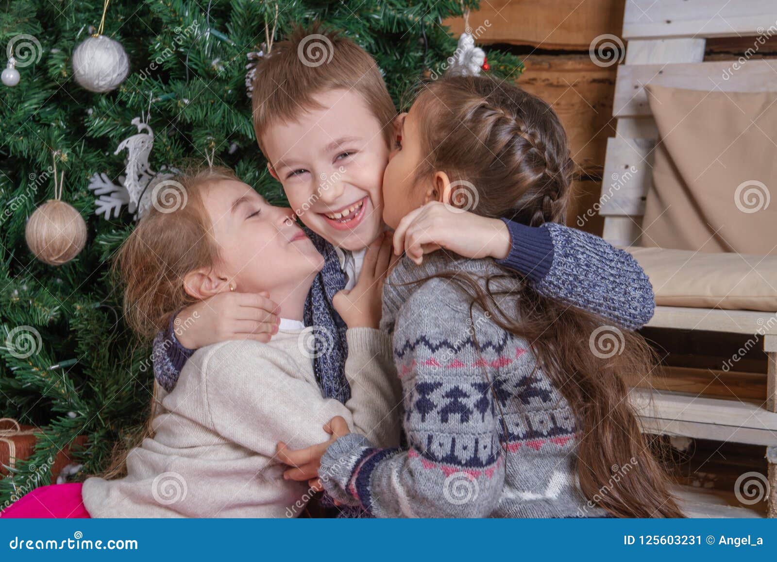 Teen Girls Kissing Brother Under Christmas Tree Everybody Laugh Sto