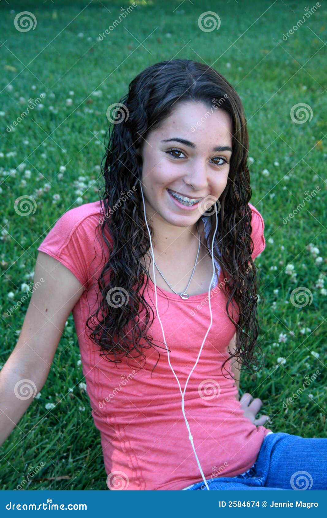 teen with ipod at the park