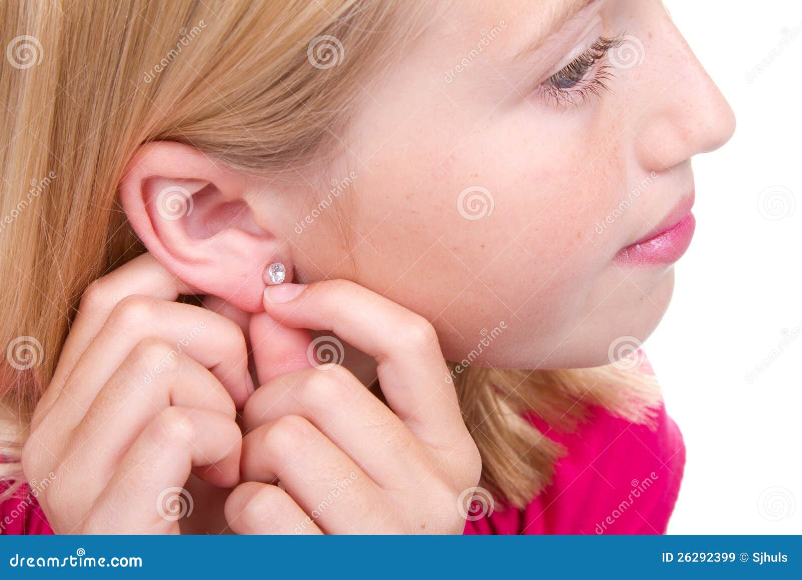 Teen putting in ear ring stock image. Image of caucasian 26292399
