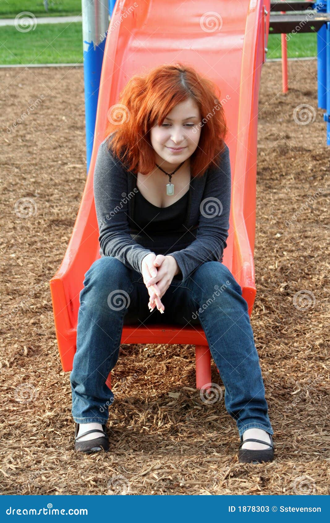 Teen Reminiscing at Playground Vertical Stock Image - Image of ...