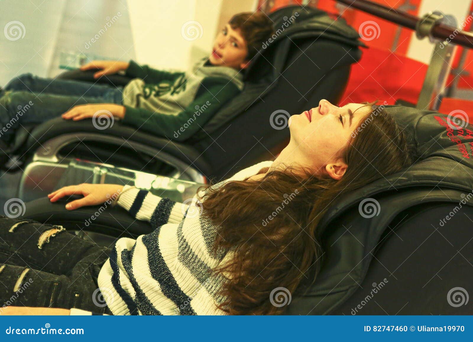 Teen Siblings Brother And Sister In Massage Chair Stock