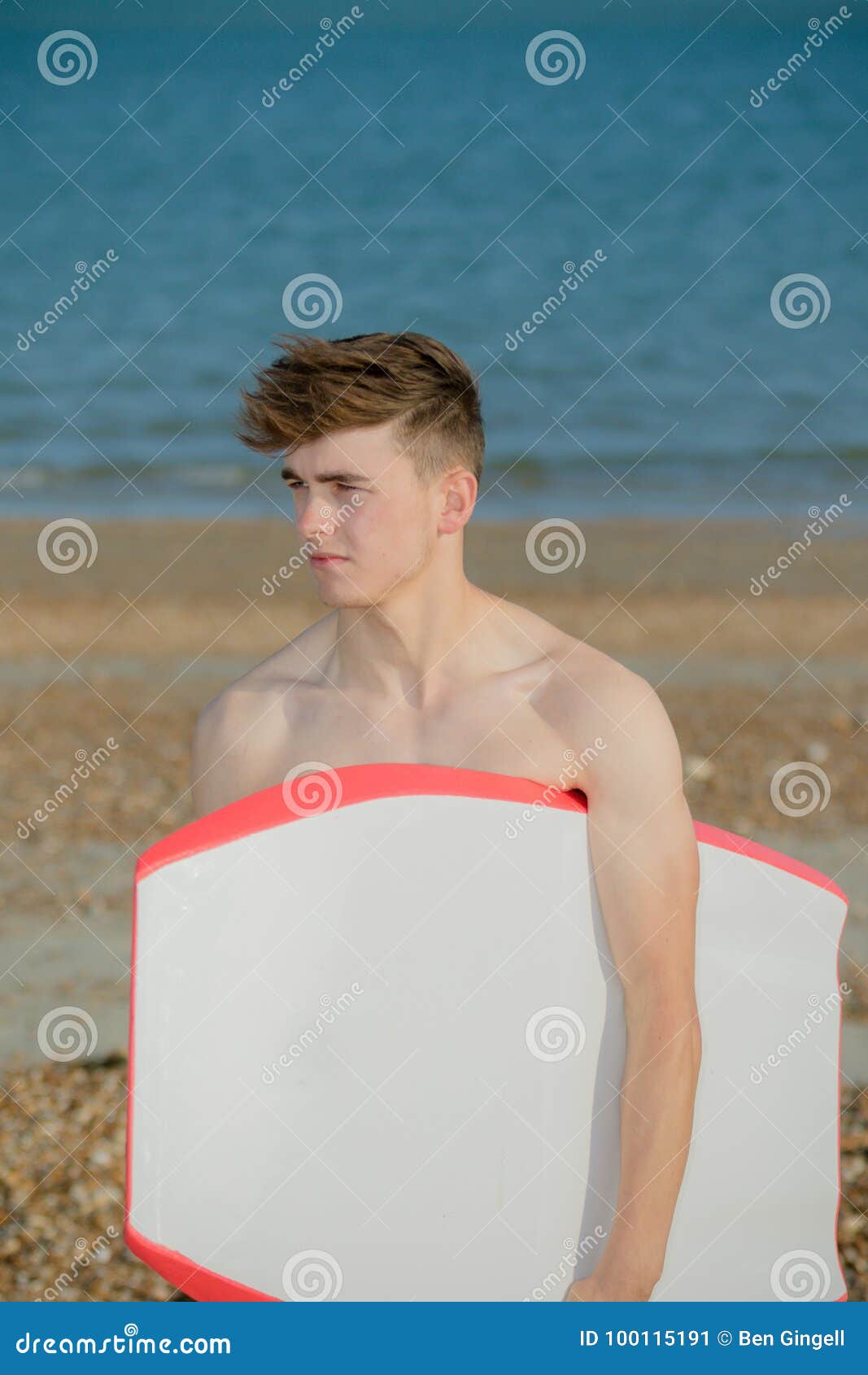 Teenage boy at the beach stock image. Image of teen - 100115191