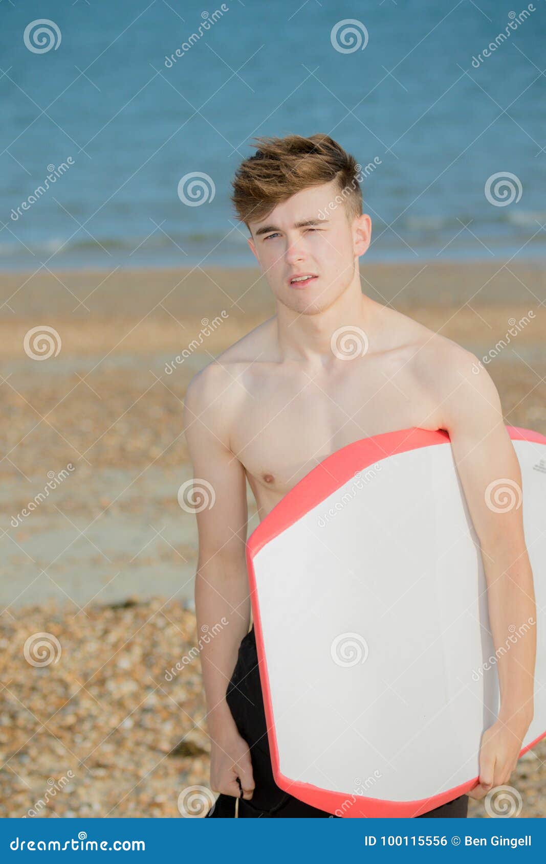 Teenage boy at the beach stock photo. Image of sunny - 100115556