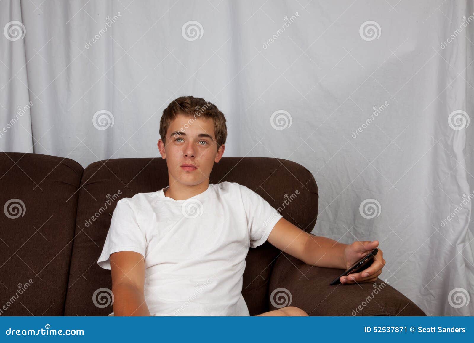 Teenage Boy on Couch stock image. Image of teen, teenager 52537871
