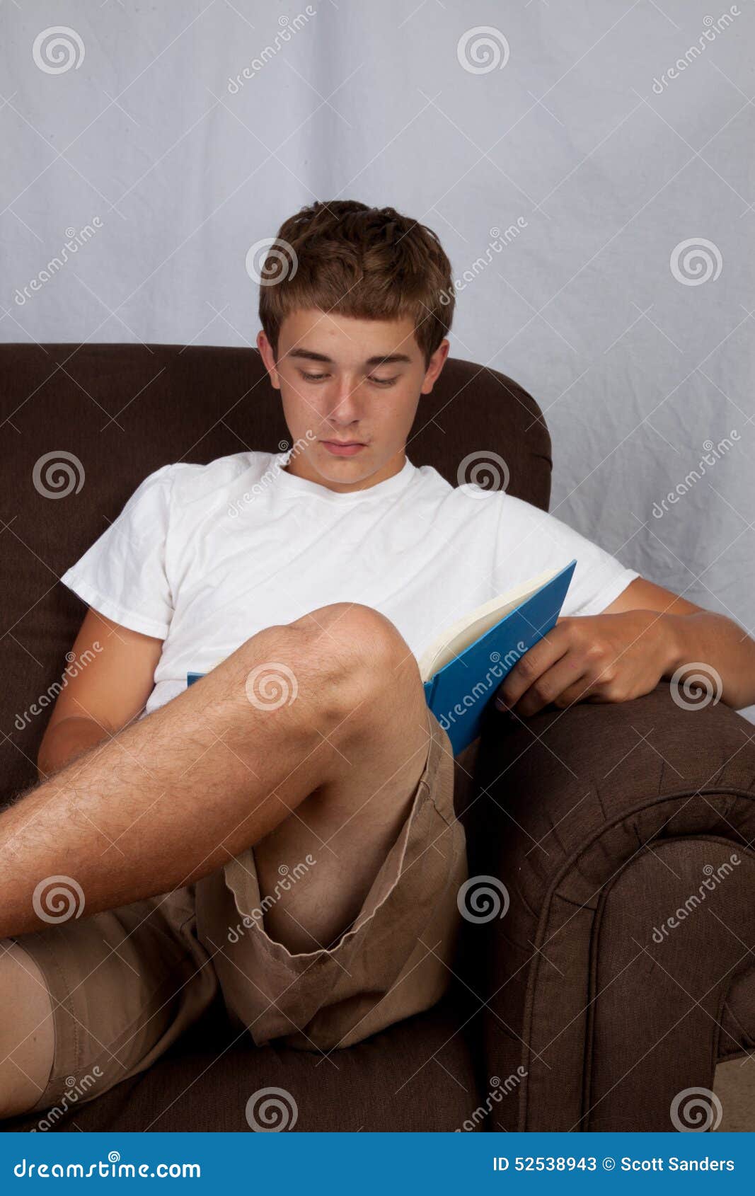 Teenage Boy on Couch stock image. Image of couch, teenager 52538943