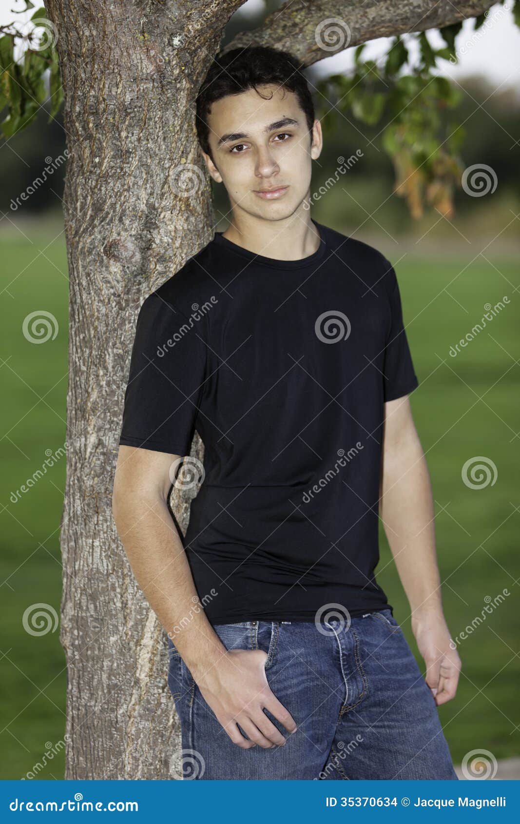 Teenage Boy Leaning Up Against a Tree. Stock Photo - Image of posing ...