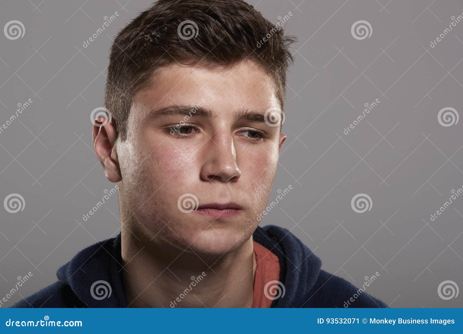 Teenage Boy Looking Down, Head and Shoulders Portrait Stock Image