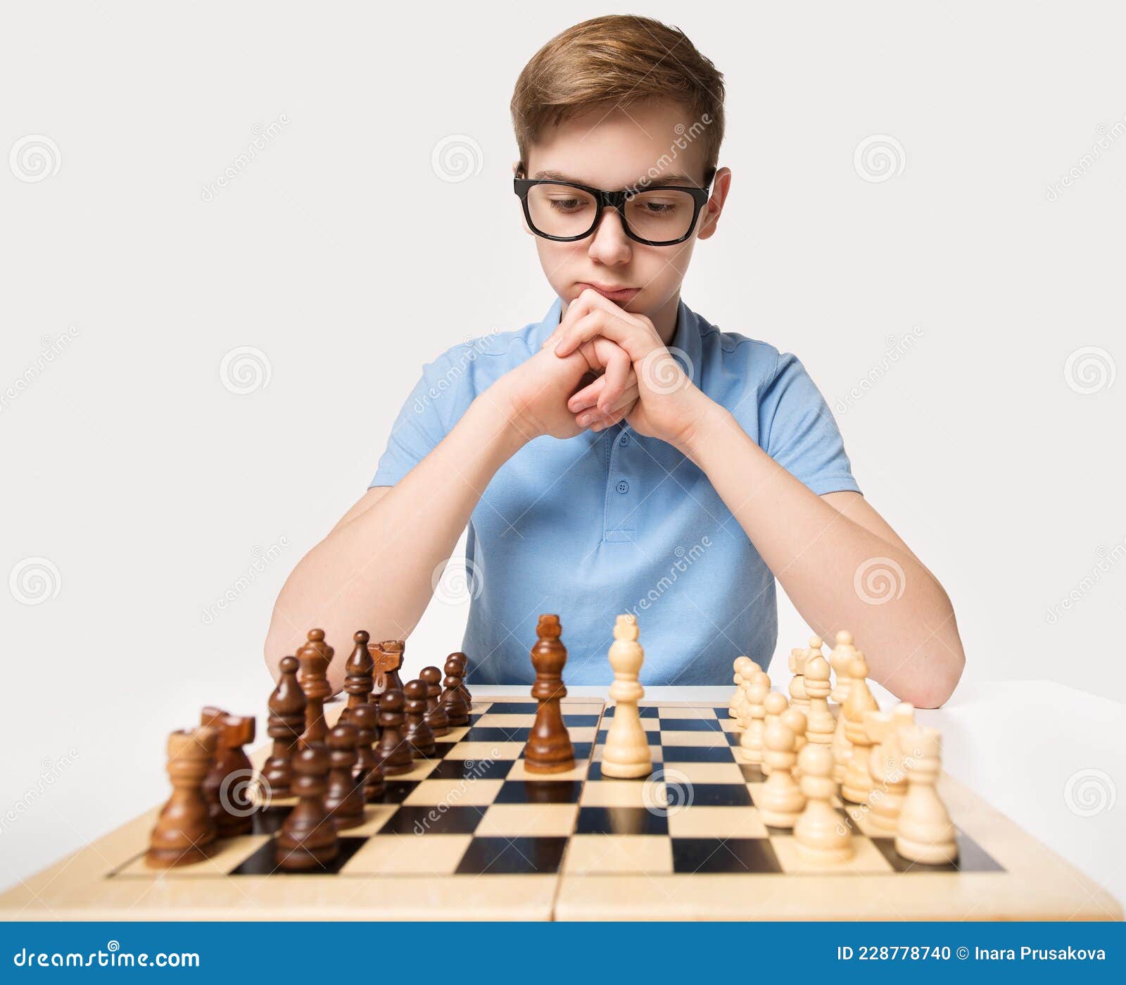 Young white child playing a game of chess on large chess board. Chess board  on table in front of school boy thinking of next move by Len44ik Vectors &  Illustrations with Unlimited