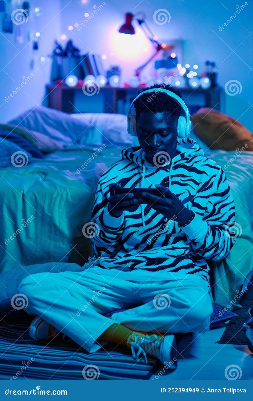 teenage boy playing game on smartphone