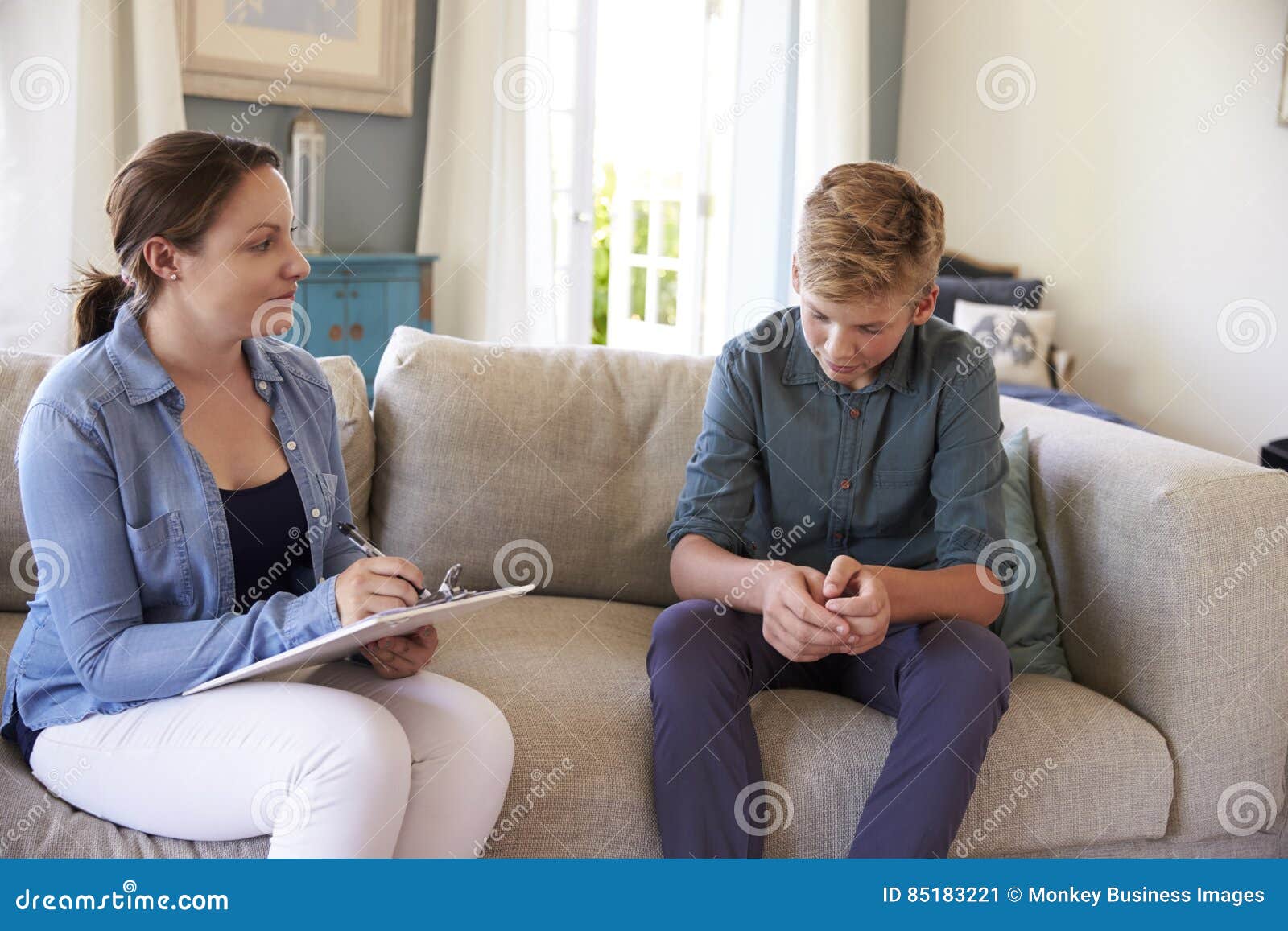 teenage boy with problem talking with counselor at home