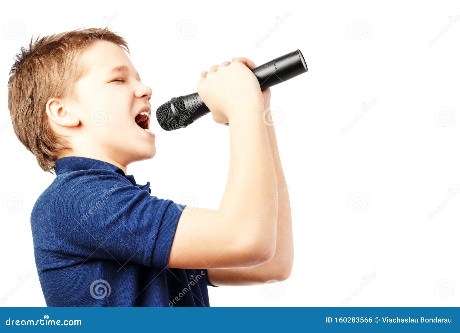 Teenage Boy Singing into a Microphone. Very Emotional Stock Photo