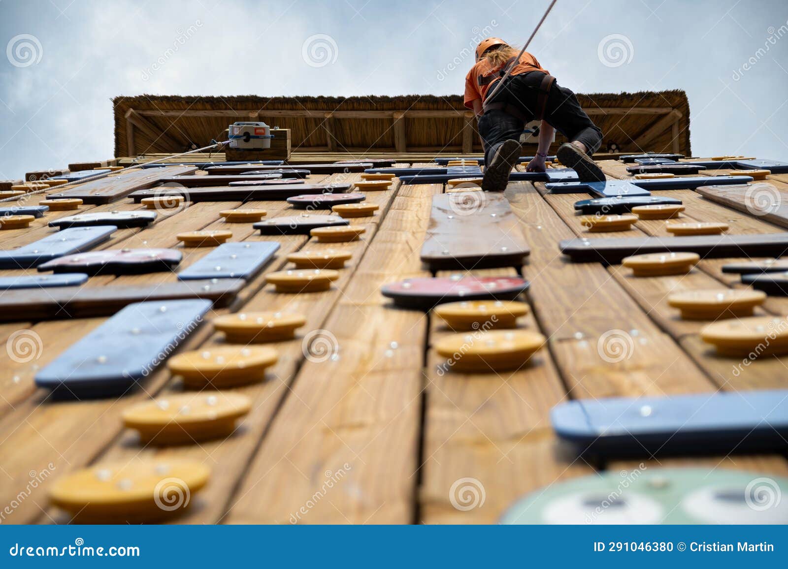 teenage boy training on climbing wall, bottom view. (palestra)