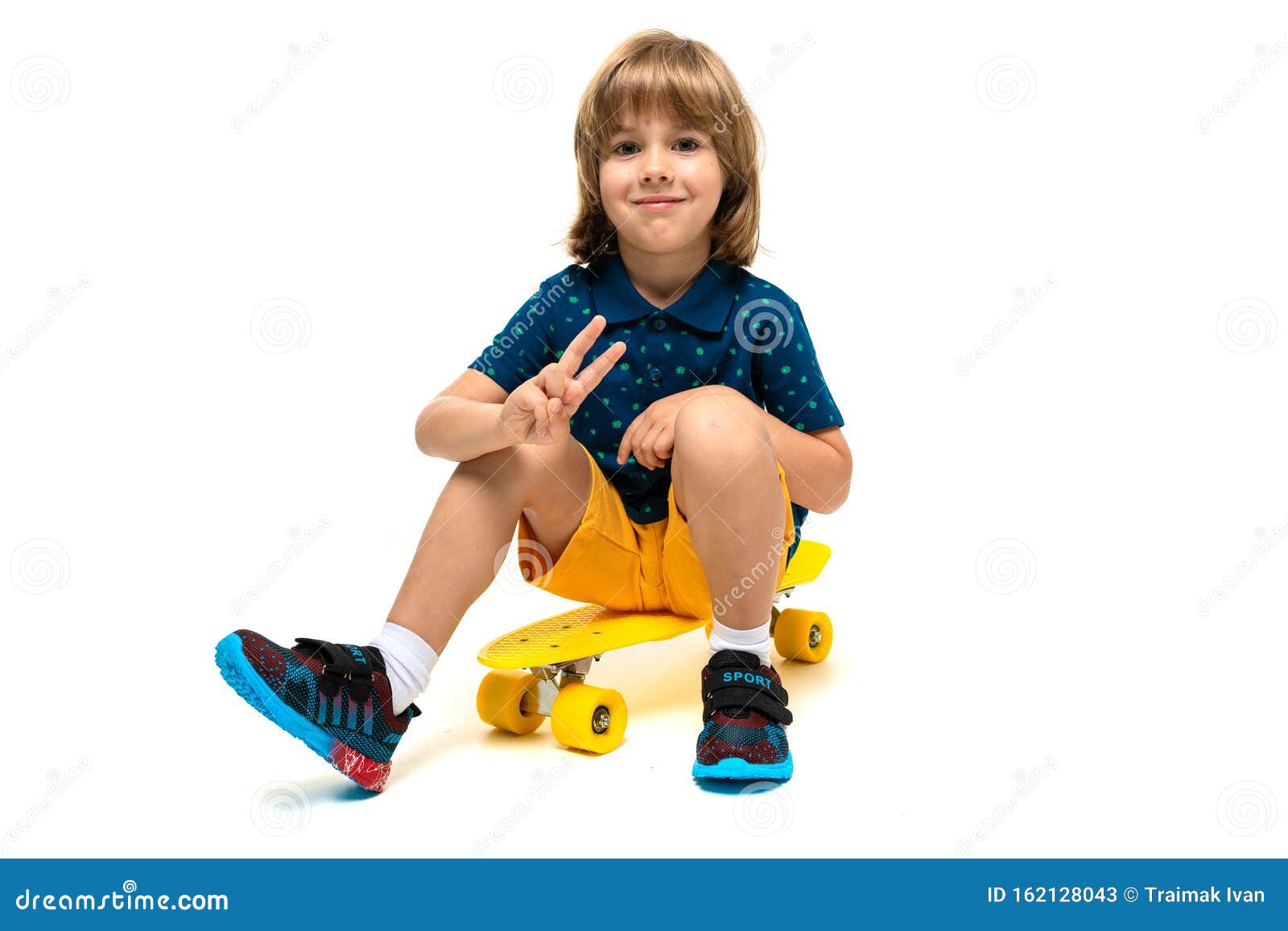 A Teenage Caucasian Boy Sits On Yellow Penny, Picture Isolated On White ...