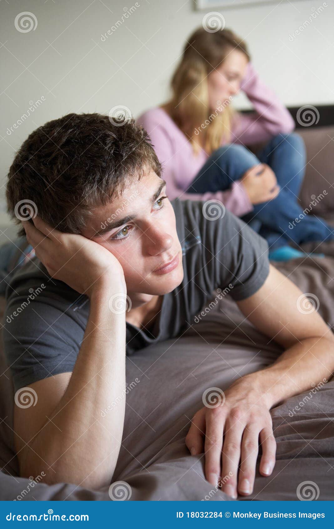 Teenage Couple In Bedroom After Argument Stock Phot