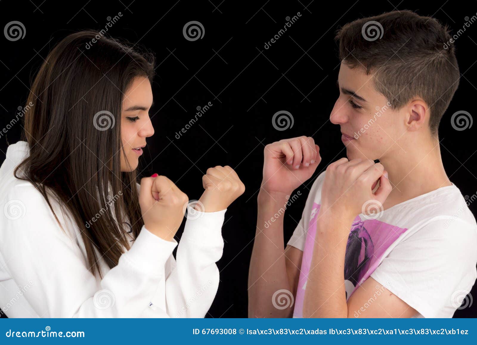 teenage couple imitating a fight