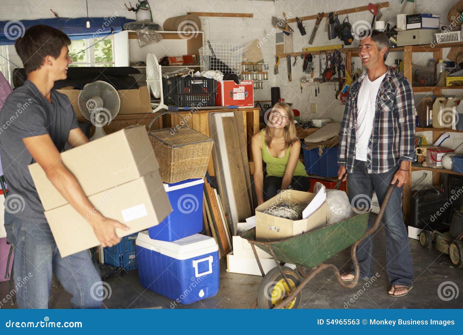 teenage family clearing garage for yard sale