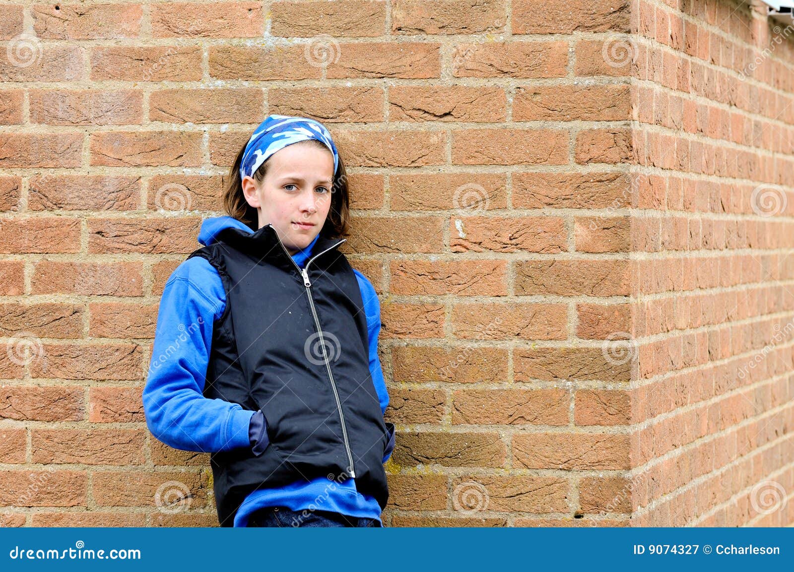 Photo of Woman Leaning on Brick Wall Posing · Free Stock Photo