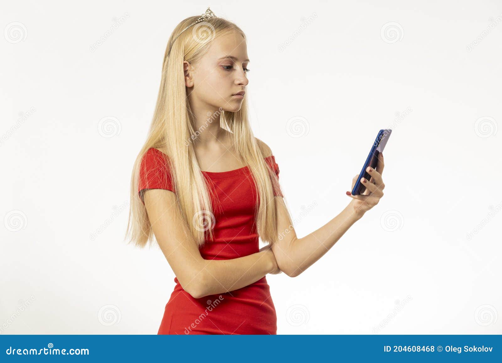 Teenage Girl with Blond Hair in Red Dress Holds Phone Stock Photo ...