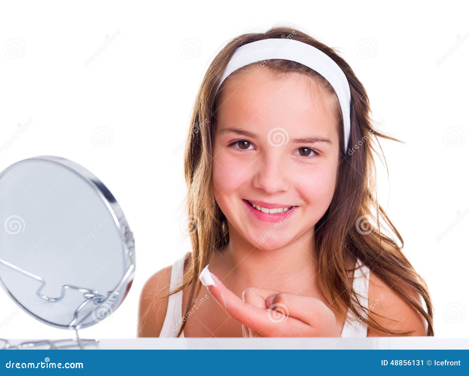 teenage girl creaming her face