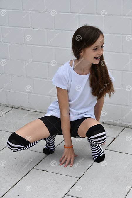 Teenage girl crouching stock image. Image of attitude - 72560841