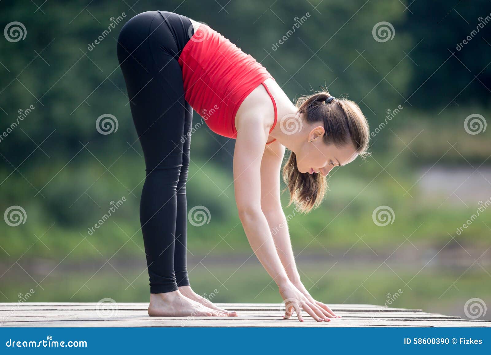 Teenage Girl Doing Intense Forward-Bending Pose Stock Photo