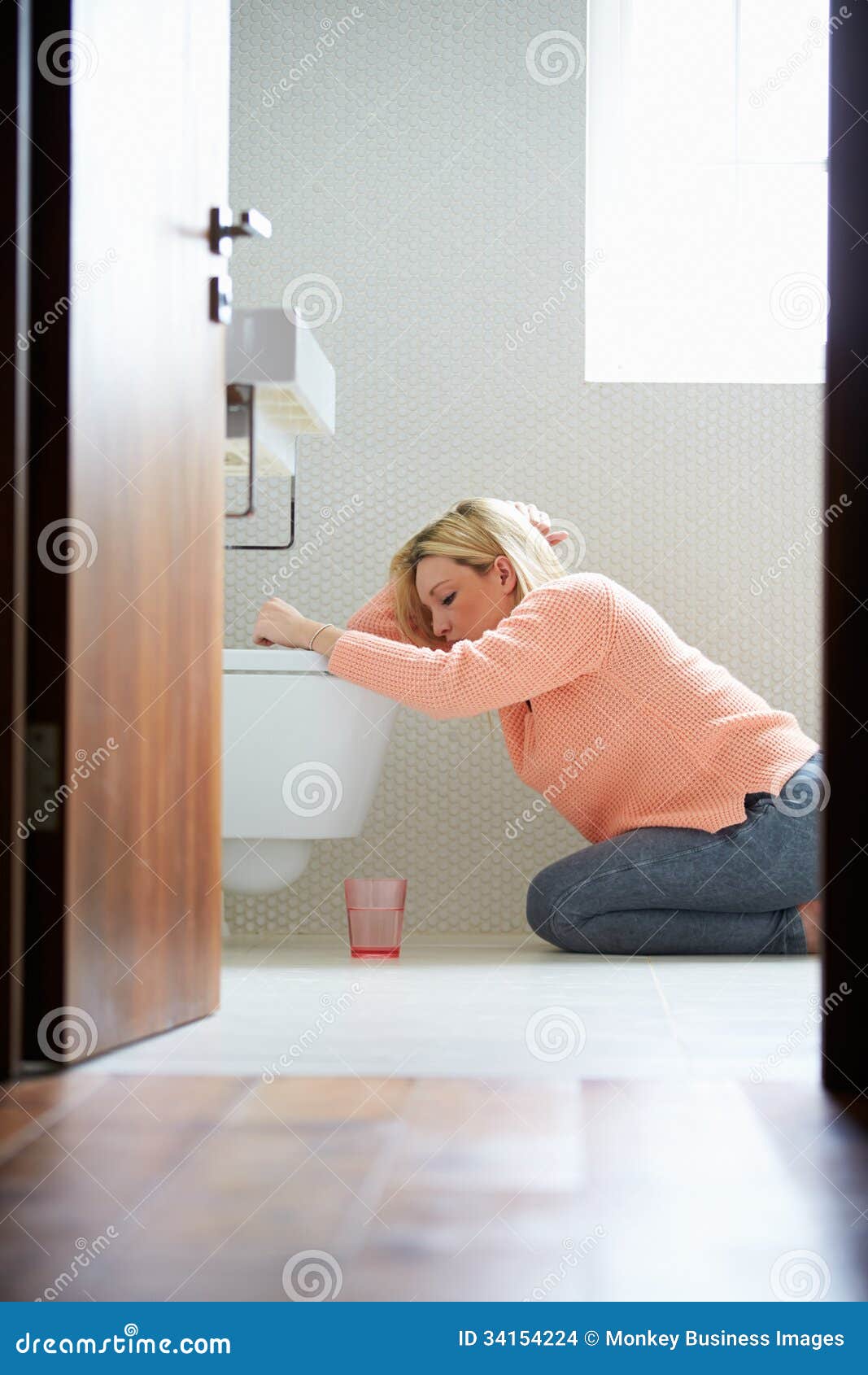 teenage girl feeling unwell in bathroom