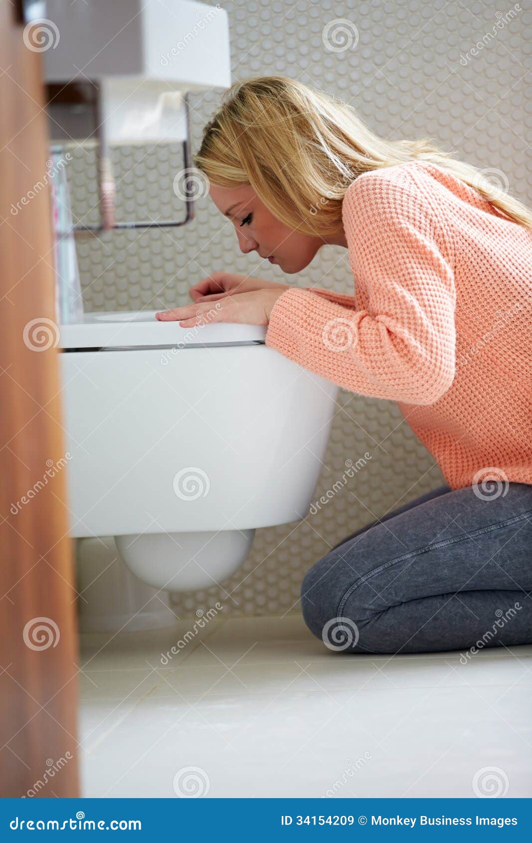teenage girl feeling unwell in bathroom