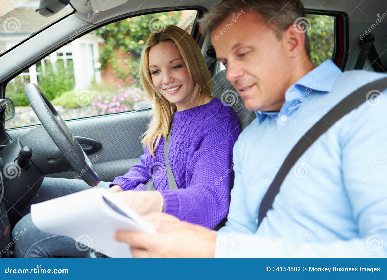 teenage girl having driving lesson with instructor