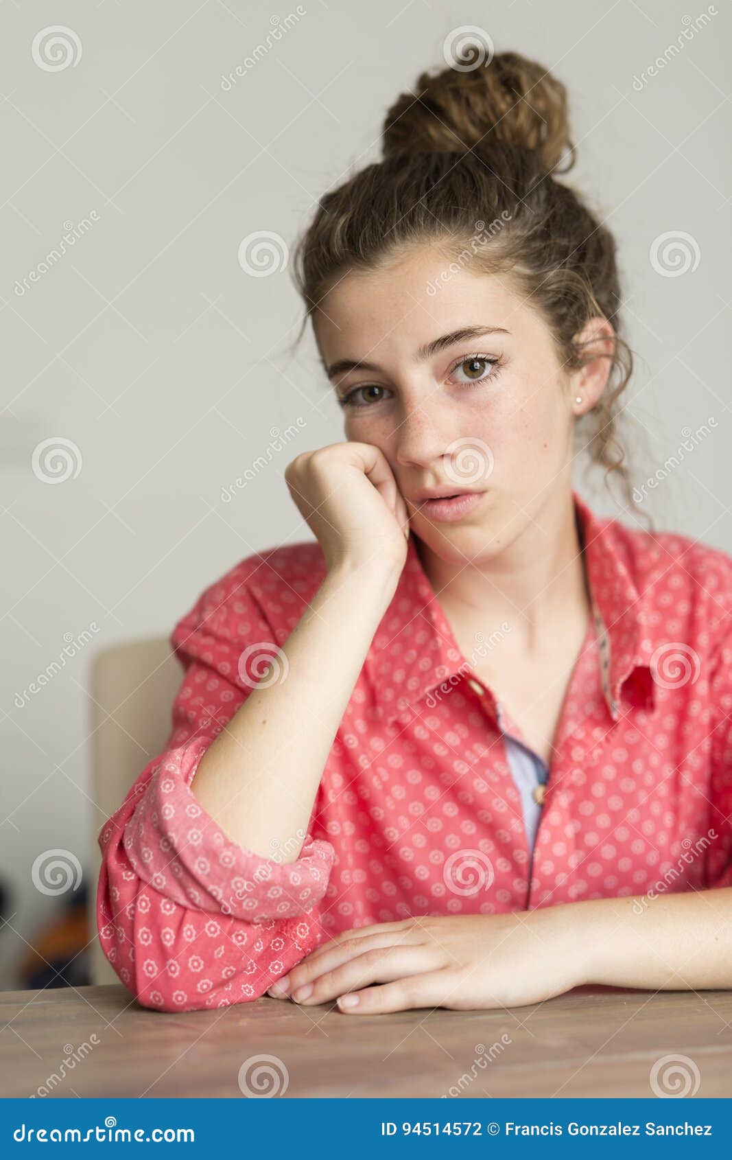 teenage girl looking at camera with serious face.