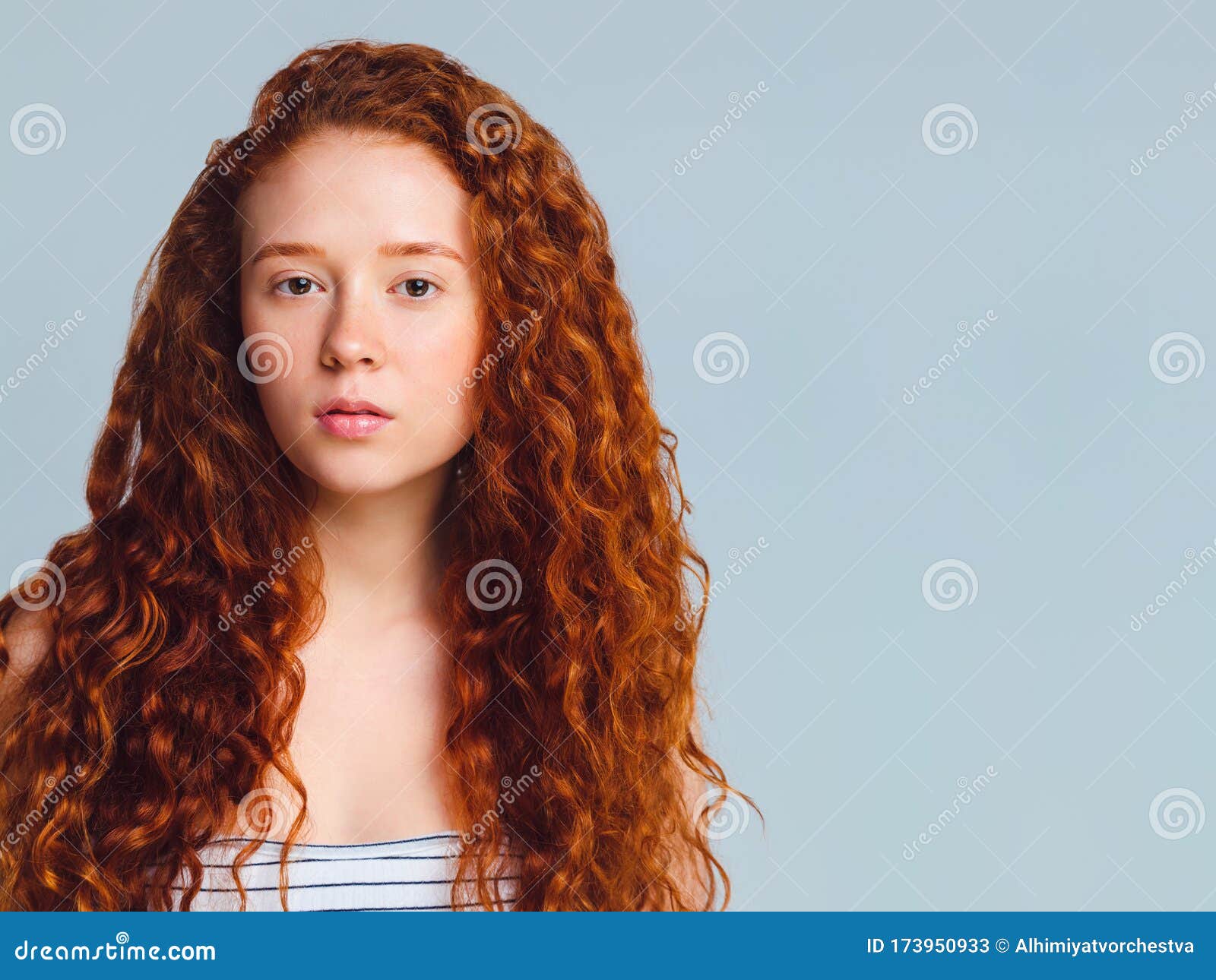 Teenage Girl with Luxurious Long Curly Red Hair on a Blue Background in the  Studio Stock Image - Image of blue, curly: 173950933