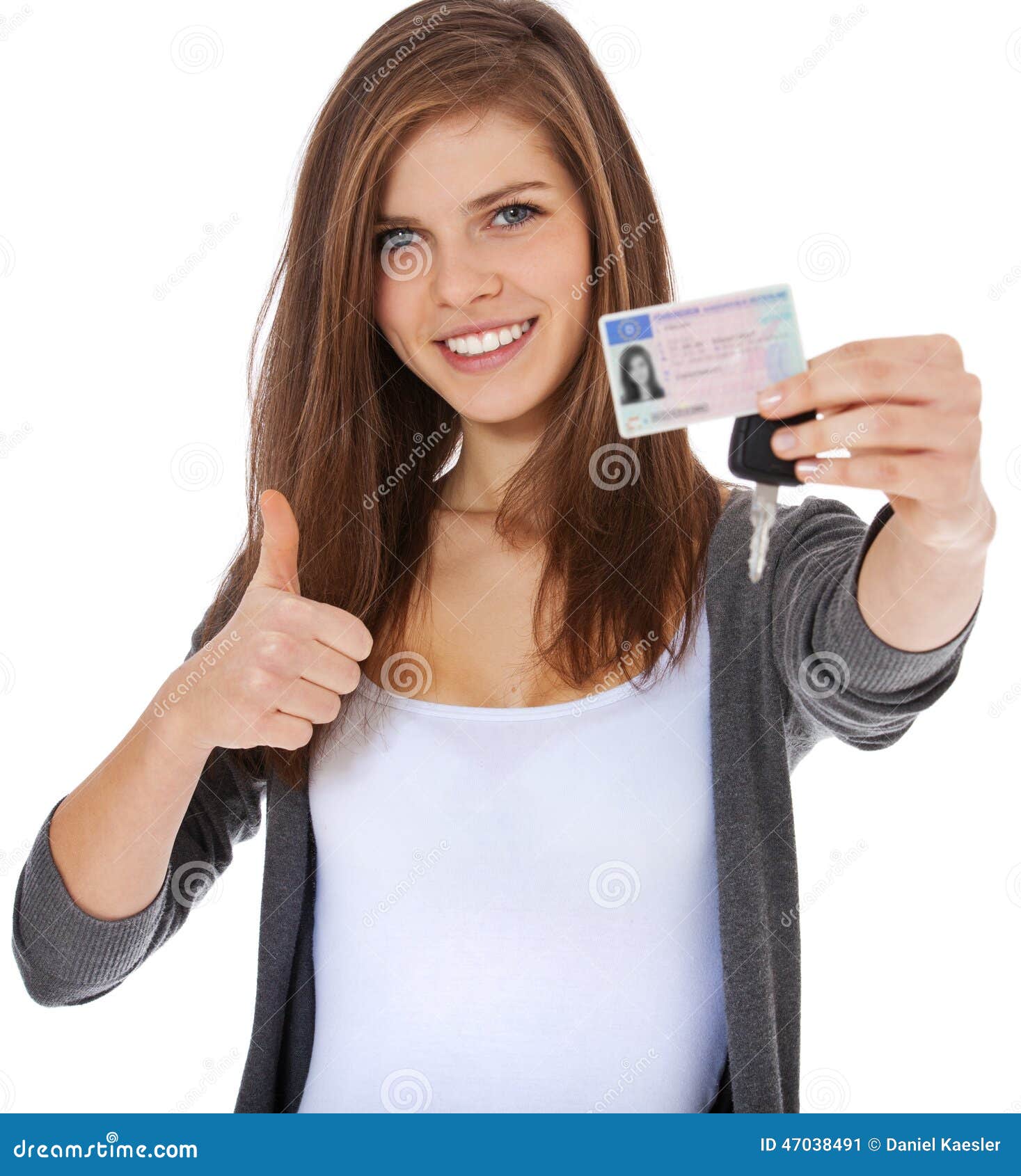 teenage girl proudly showing her driver licence