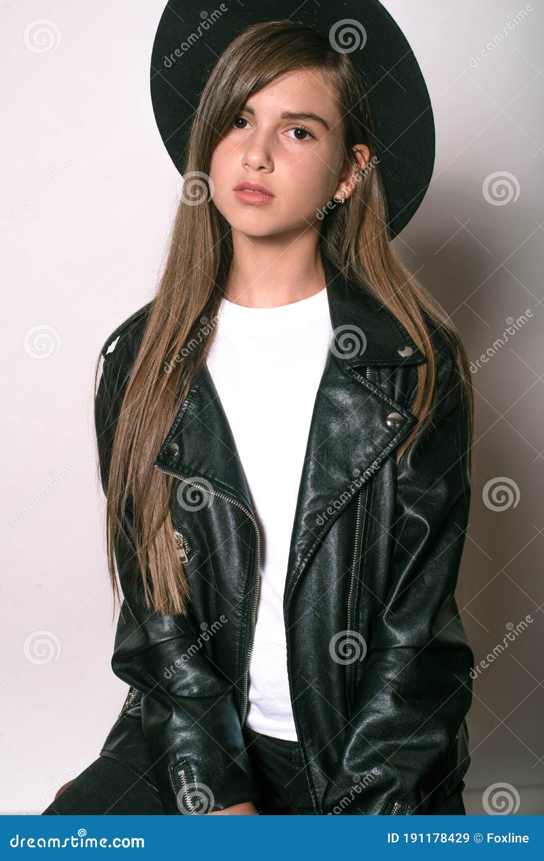 A Teenage Girl in a Trendy Leather Jacket and an Even Hat on a White ...