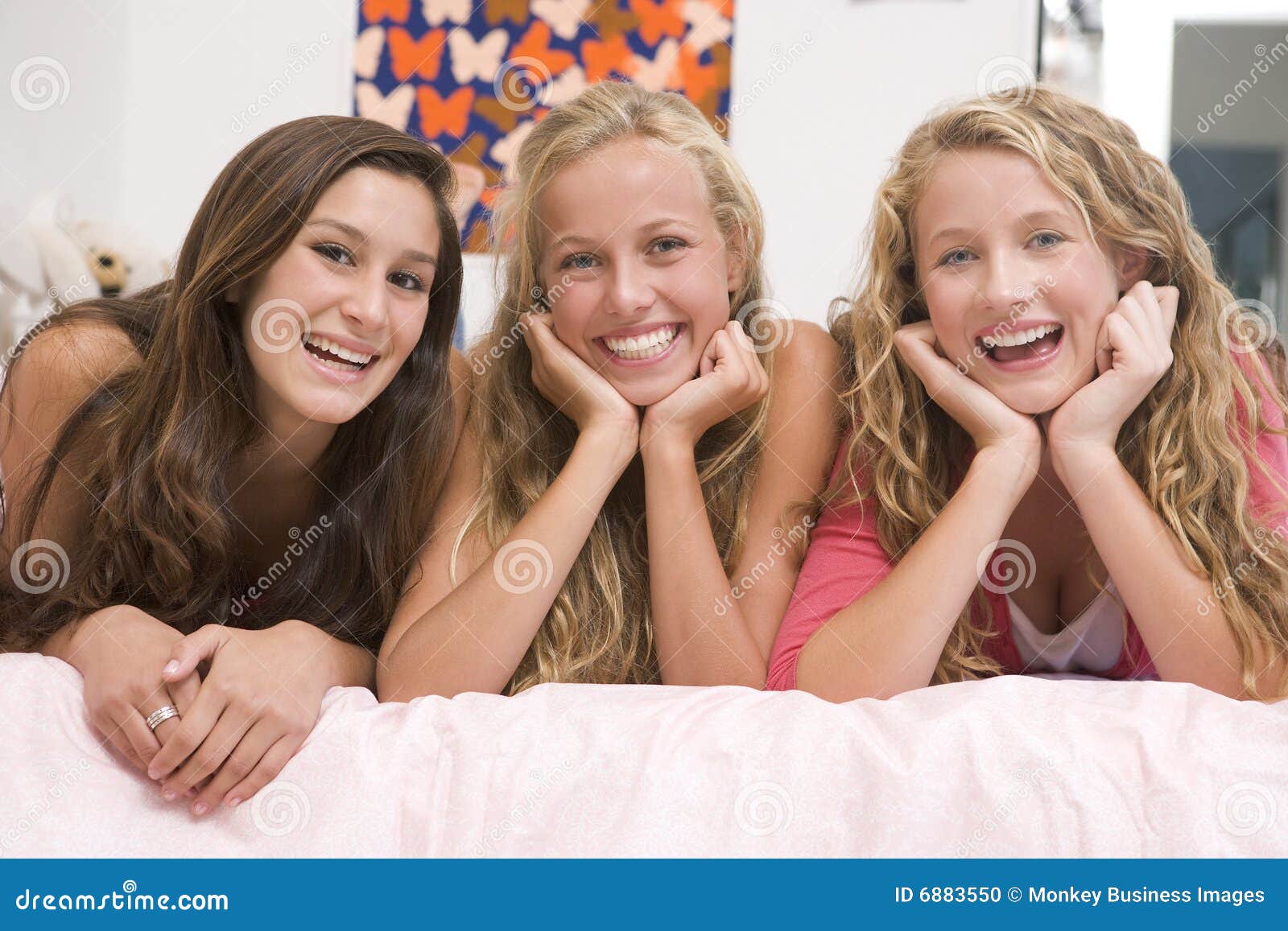 Teenage Girls In A Bedroom Fist Bumping Friendship Concept Royalty Free