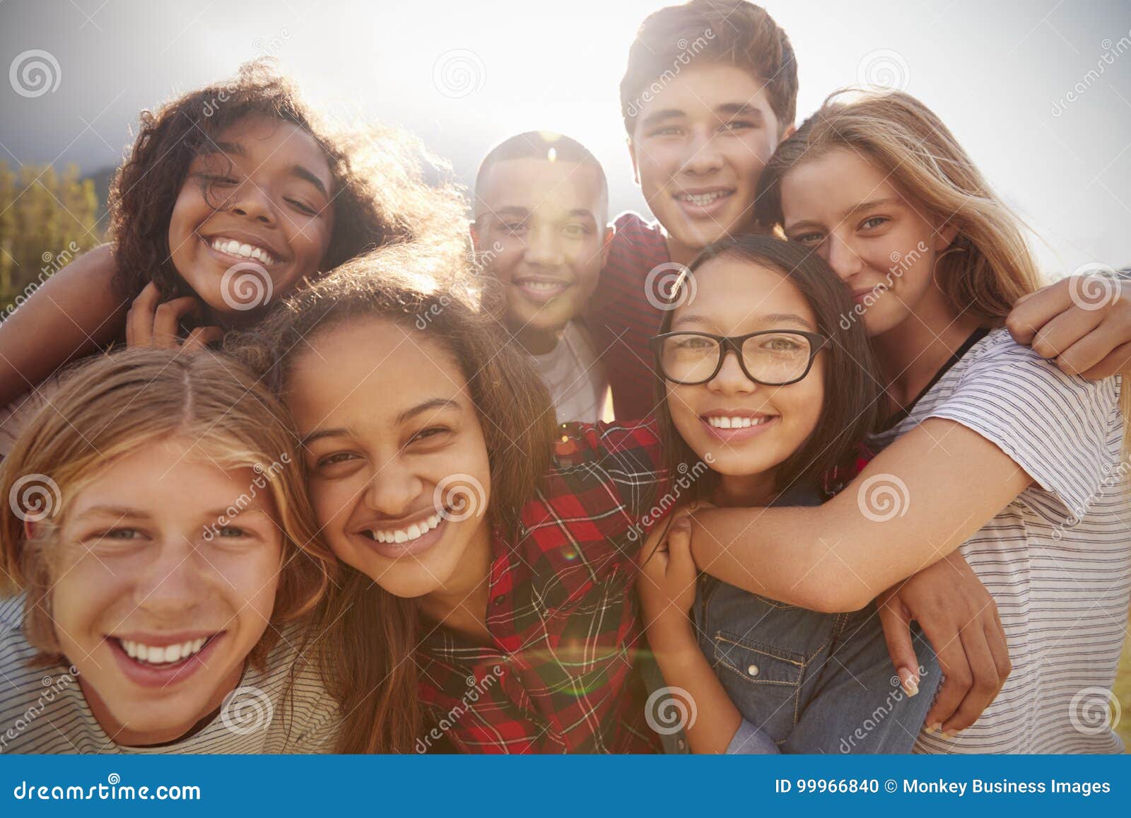 teenage school friends smiling to camera, close up